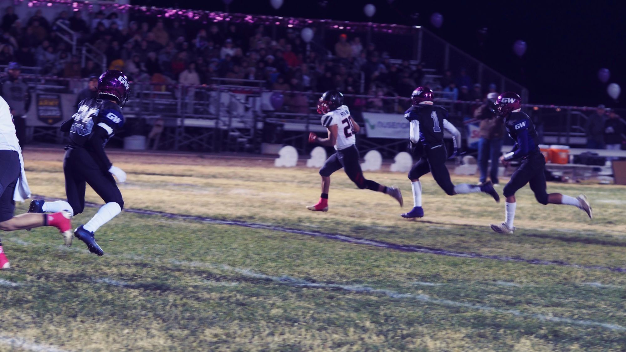 Three football players from Gateway Christian High converge on a player from Mountainair High.