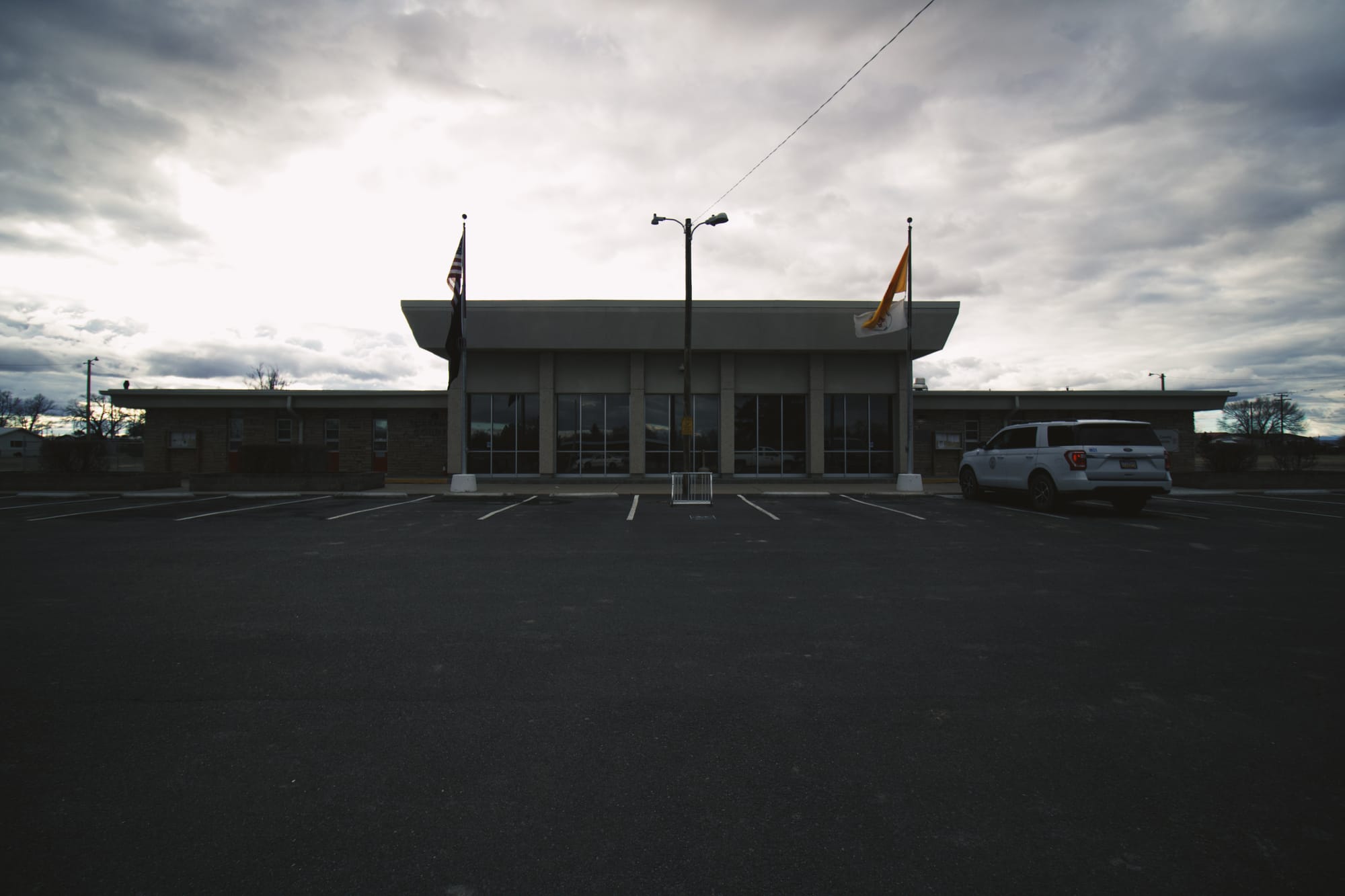 Torrance County Government Offices - a seventies-era Brutalist government building beneath ominous clouds